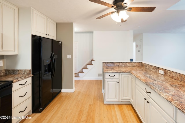 kitchen with black appliances, white cabinets, light hardwood / wood-style flooring, ceiling fan, and stone countertops