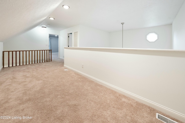 interior space with light carpet and lofted ceiling