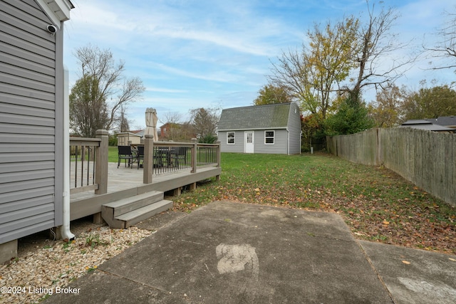 view of yard featuring an outbuilding and a wooden deck