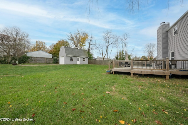 view of yard featuring a wooden deck and an outdoor structure