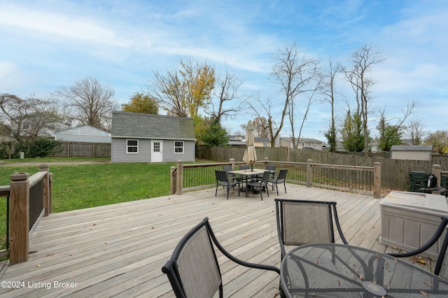 deck featuring a yard and an outbuilding