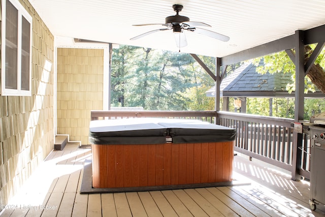 deck featuring a hot tub and a ceiling fan