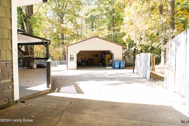 detached garage featuring fence