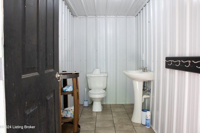 bathroom with toilet and tile patterned flooring