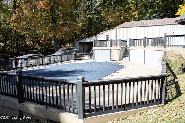 view of pool featuring a covered pool, stairway, and a wooden deck