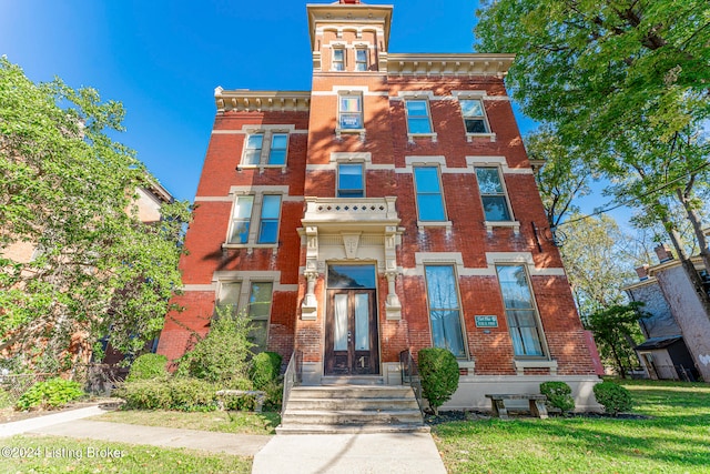 italianate-style house with a front lawn