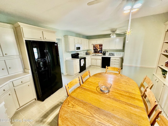 kitchen with black appliances, sink, ceiling fan, white cabinets, and light tile patterned floors