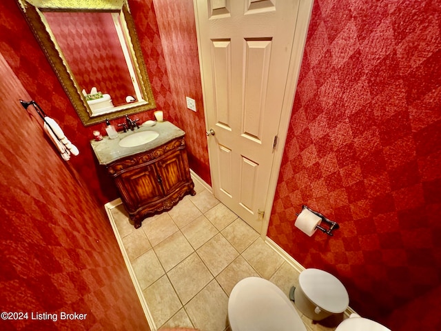 bathroom featuring toilet, vanity, and tile patterned flooring