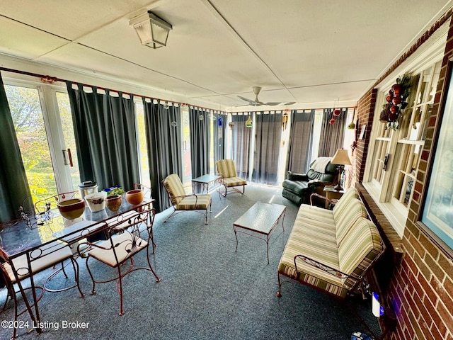 sunroom / solarium featuring ceiling fan