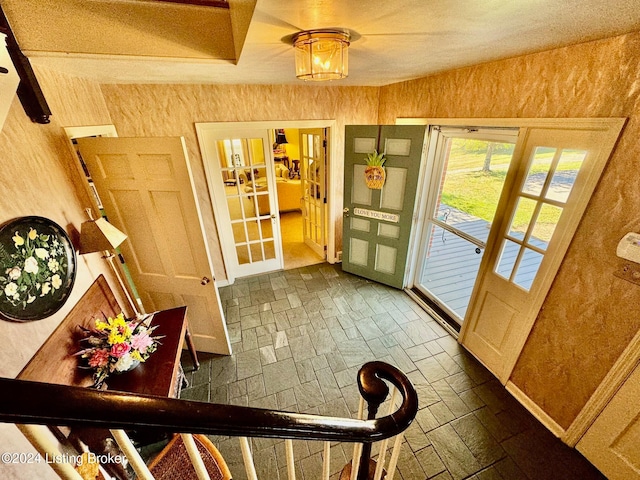 doorway featuring french doors and an inviting chandelier