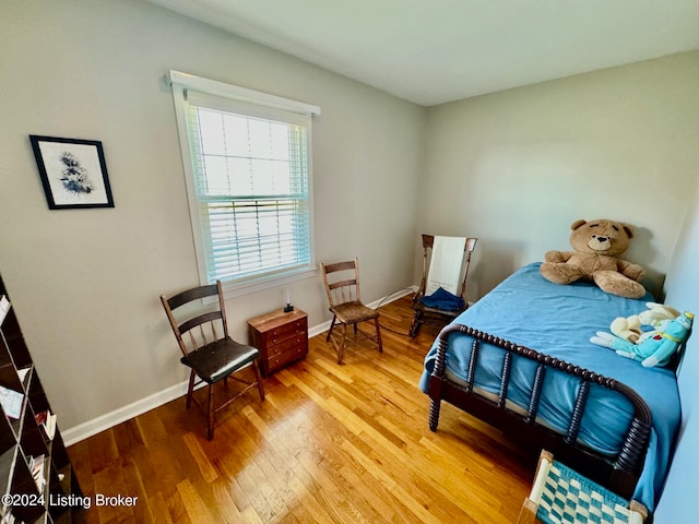 bedroom with hardwood / wood-style flooring