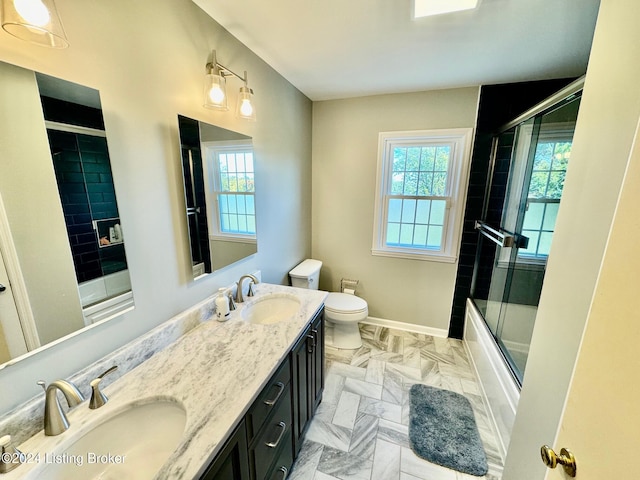 full bathroom with vanity, toilet, and bath / shower combo with glass door