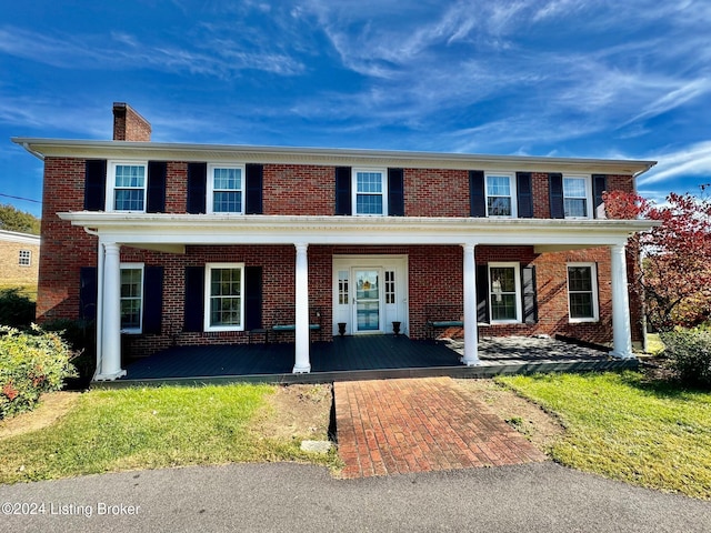 view of front facade with a front lawn and a porch