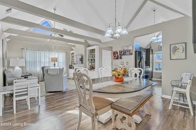 dining space featuring beam ceiling, high vaulted ceiling, wood-type flooring, and a chandelier