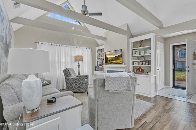 living room with light hardwood / wood-style floors, beamed ceiling, high vaulted ceiling, and ceiling fan