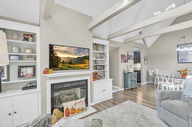 living room featuring beamed ceiling, hardwood / wood-style floors, and high vaulted ceiling