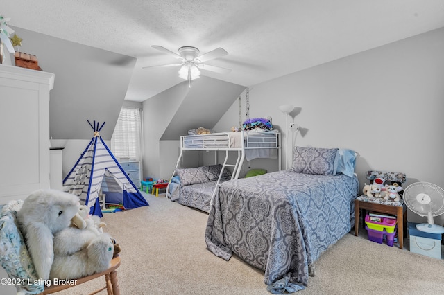 bedroom with lofted ceiling, a textured ceiling, carpet floors, and ceiling fan