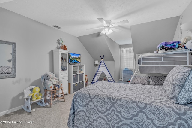 carpeted bedroom featuring ceiling fan, a textured ceiling, and lofted ceiling