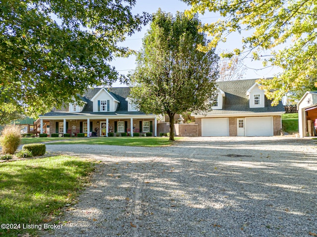 cape cod house featuring a front yard, a garage, and a porch