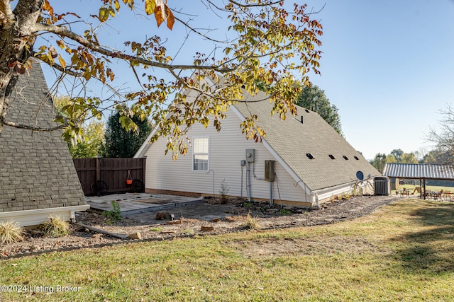 view of property exterior featuring cooling unit, a patio area, and a lawn