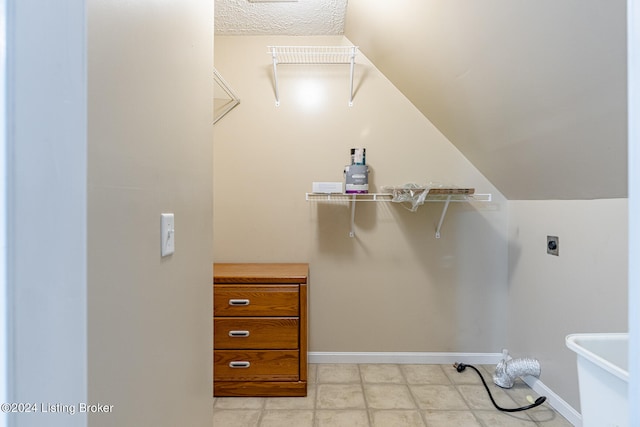 walk in closet with lofted ceiling