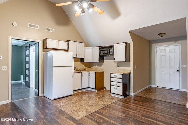 kitchen featuring white cabinetry, hardwood / wood-style flooring, high vaulted ceiling, and white refrigerator