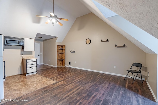 175 Boone White Rd, Leitchfield, KY 42754 - additional living space featuring dark wood-style floors, a skylight, ceiling fan, baseboards, and high vaulted ceiling