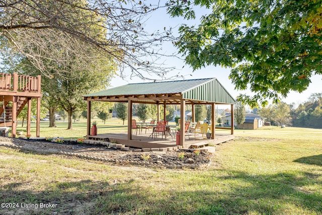 view of community with a gazebo, a deck, and a lawn