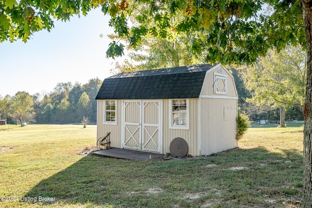 view of outbuilding featuring a lawn