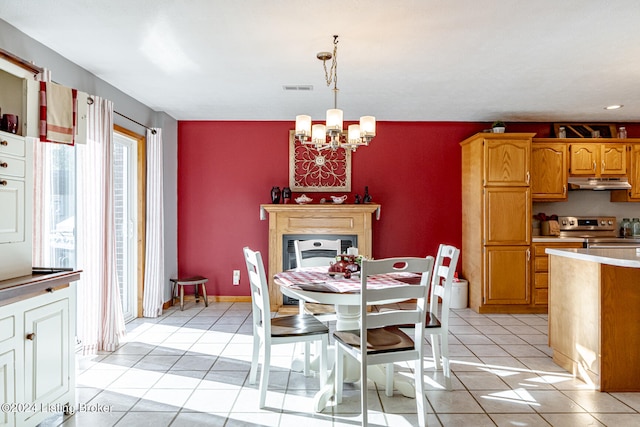 dining space featuring light tile patterned floors and an inviting chandelier