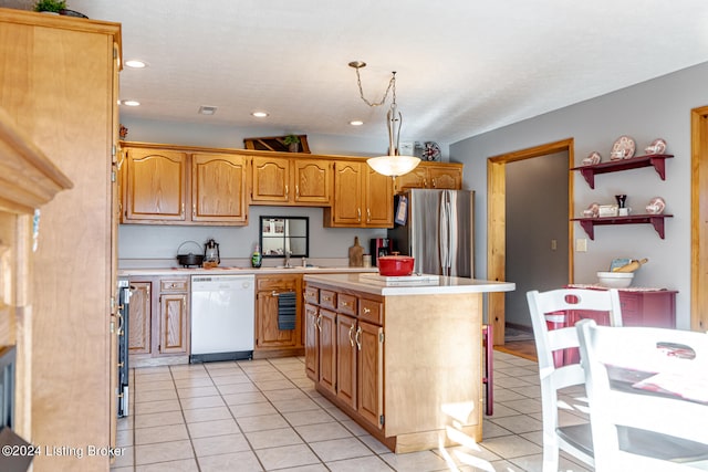 kitchen featuring white dishwasher, stainless steel fridge, a center island, light tile patterned flooring, and decorative light fixtures