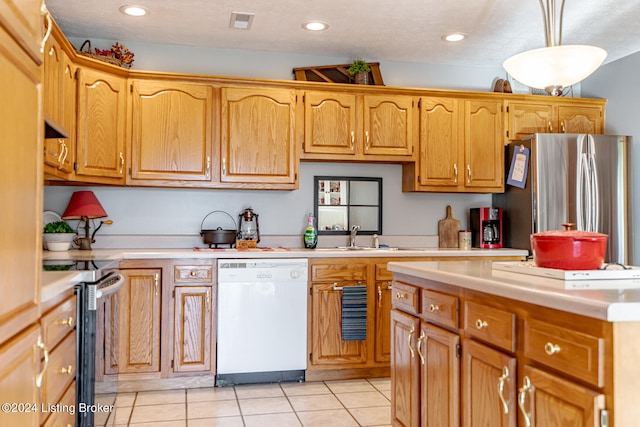 kitchen featuring sink, hanging light fixtures, stainless steel appliances, and light tile patterned floors