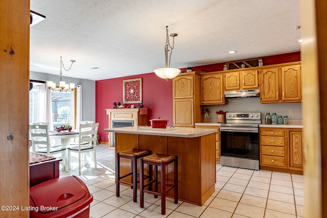 kitchen with a kitchen island, a chandelier, electric range, and pendant lighting