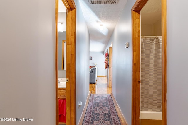 175 Boone White Rd, Leitchfield, KY 42754 - hallway featuring baseboards, wood finished floors, and a sink