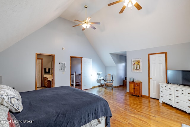 bedroom with ensuite bathroom, high vaulted ceiling, light wood-type flooring, and ceiling fan