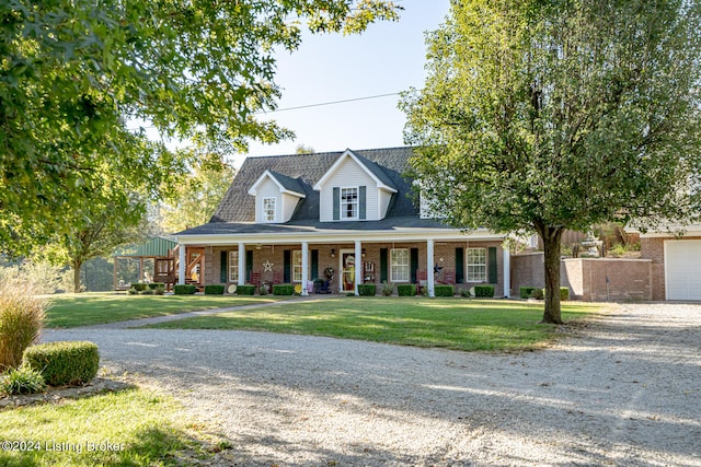 view of front facade with a front yard, a garage, and a porch