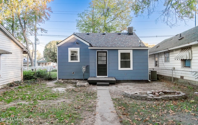 rear view of house featuring central air condition unit