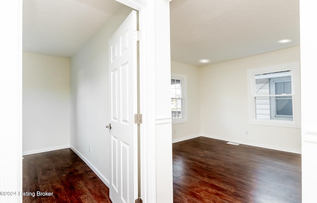 hallway with dark wood-type flooring