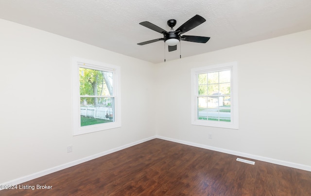 unfurnished room with dark wood-type flooring, a textured ceiling, and ceiling fan