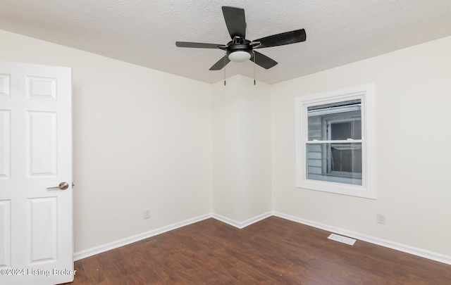 unfurnished room featuring dark hardwood / wood-style flooring, a textured ceiling, and ceiling fan