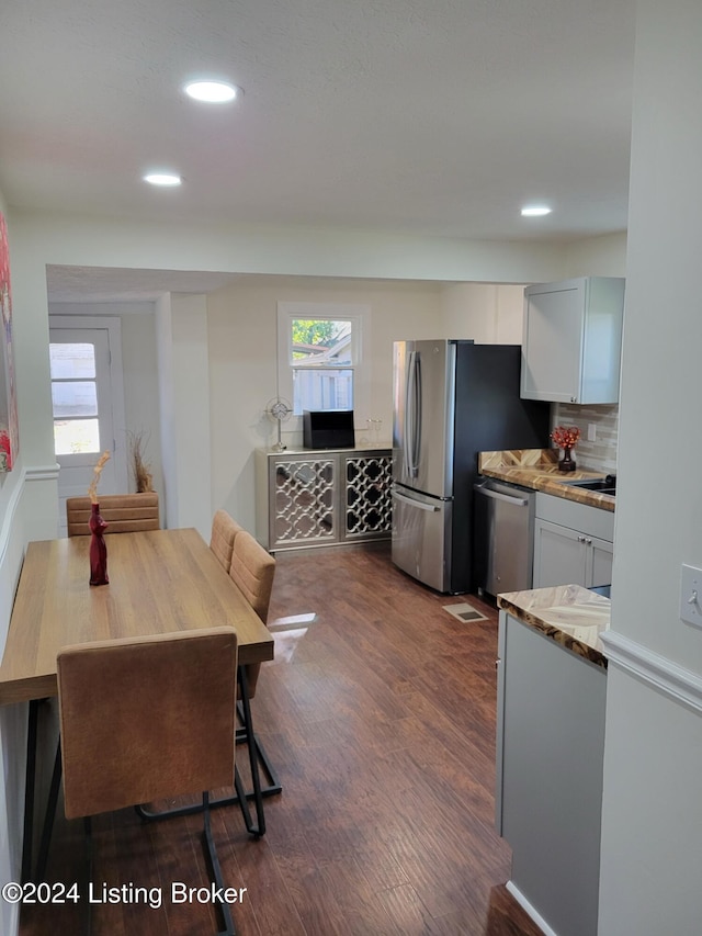 dining area featuring dark wood-type flooring