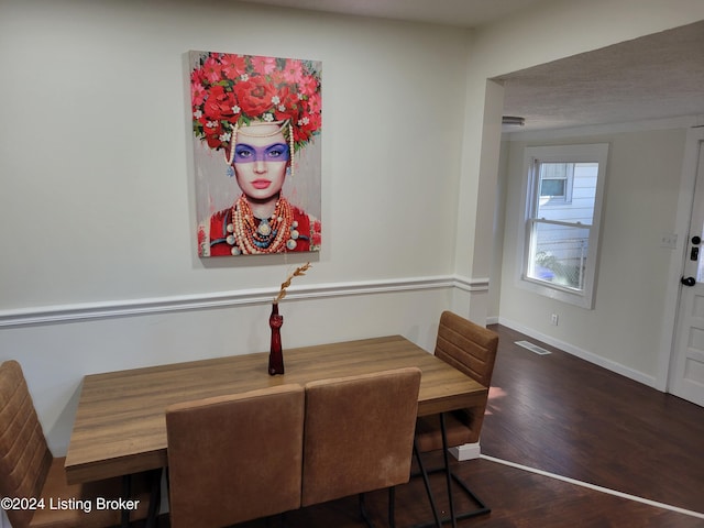 dining area featuring dark wood-type flooring