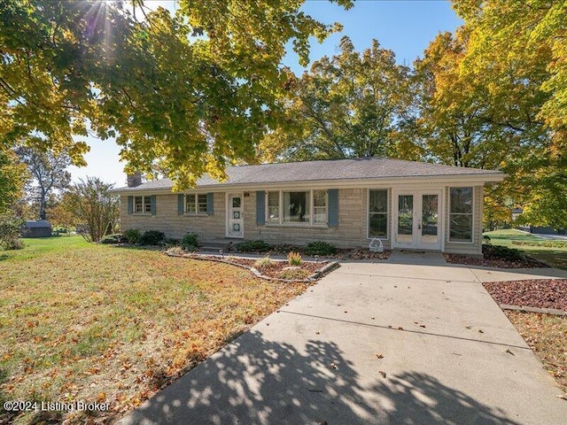 single story home featuring french doors and a front yard