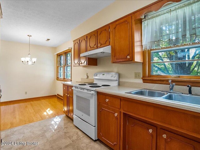 kitchen with sink, a healthy amount of sunlight, electric range, and decorative light fixtures