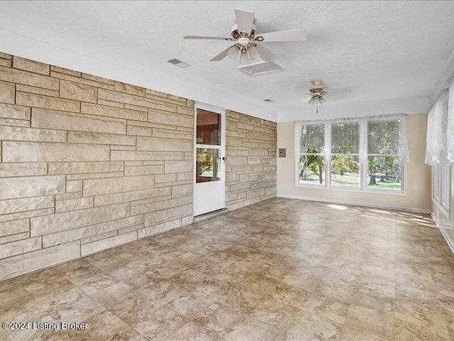 unfurnished room with a textured ceiling and ceiling fan