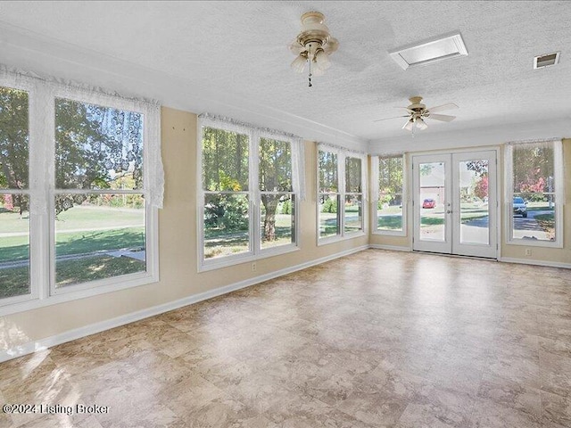 unfurnished sunroom with french doors, plenty of natural light, and ceiling fan