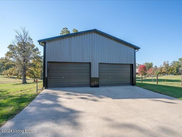 garage featuring a lawn