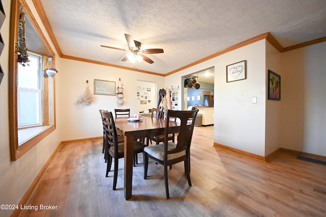 dining space featuring a textured ceiling, crown molding, hardwood / wood-style flooring, and ceiling fan