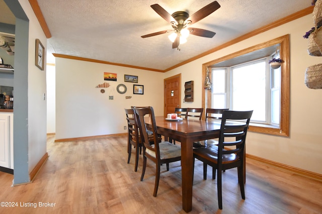 dining space featuring a textured ceiling, light wood-type flooring, and ceiling fan