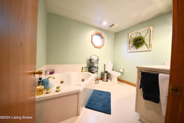 bathroom with a tub to relax in, vanity, and toilet